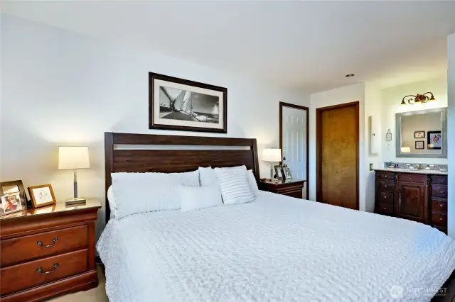 The primary ensuite has a full bath, and the white door in the background leads to the exterior. Note you are allowed to do short-term rentals in the Admiralty condos!