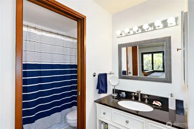 The full bathroom in the guest ensuite. By design, you can rent out this room on a nightly basis, it has an exterior door. Lock this room from your living space, and live simultaneously in your condo, while making extra income renting out this room!