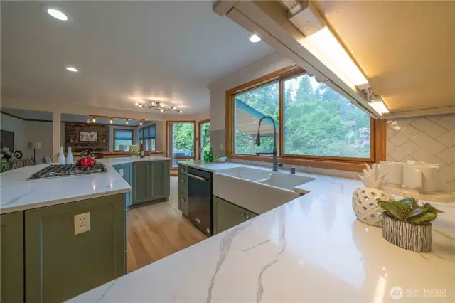 Thoughtfully remodeled kitchen, with large island, updated appliances, under cabinet lighting, gas cooktop, plenty of cabinet and counter space!  Don't miss the soft close drawers too!