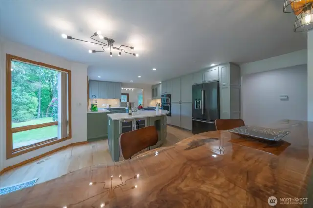 The wood you see in the foreground is a polished maple slab seats 4+ easily and overlooks the family room from the kitchen side.   You must see it to appreciate it!