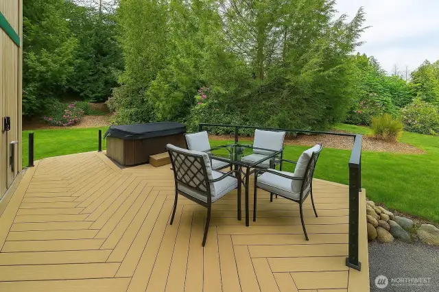 Large herringbone deck features family sized hot tub with "easy assist" lid, lots of room for seating, and covered barbecue area for year-round barbecuing.