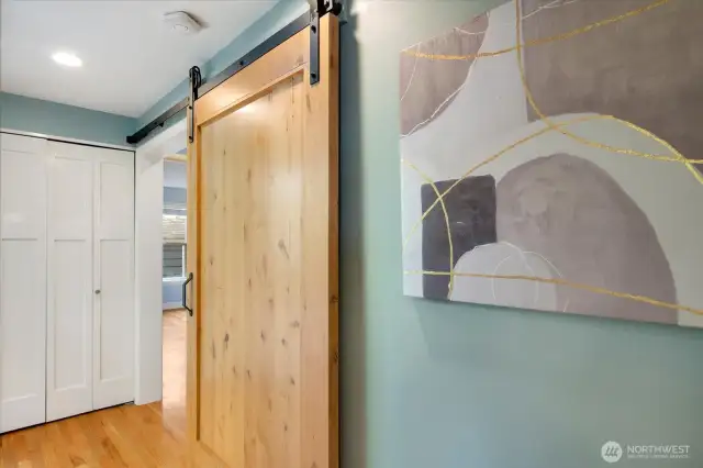 Rustic charm with a stylish barn-style sliding hallway door.