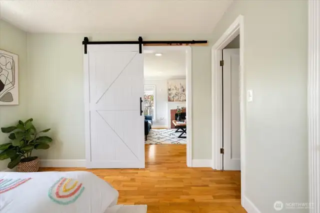 Barn-style door offers flexible living—easily create privacy or open up your space for a seamless flow.