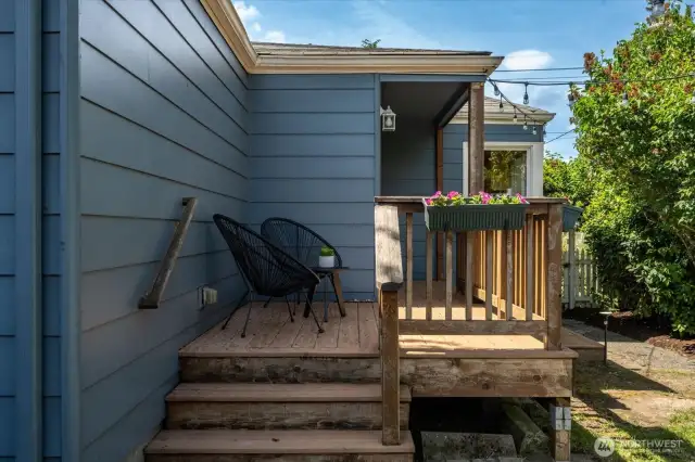 The back porch enhanced with built-in planters, adding greenery and inviting nature right to your doorstep.