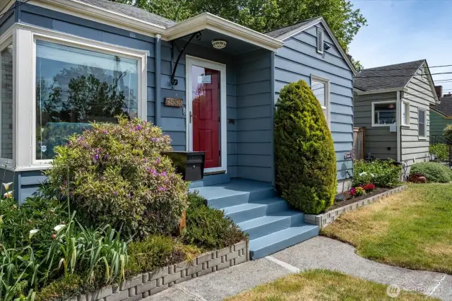 Mature plantings and lots of space for gardening, pops of color and soaking in the neighborhood views.
