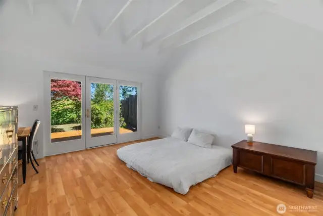 primary room w doors to back yard deck & views