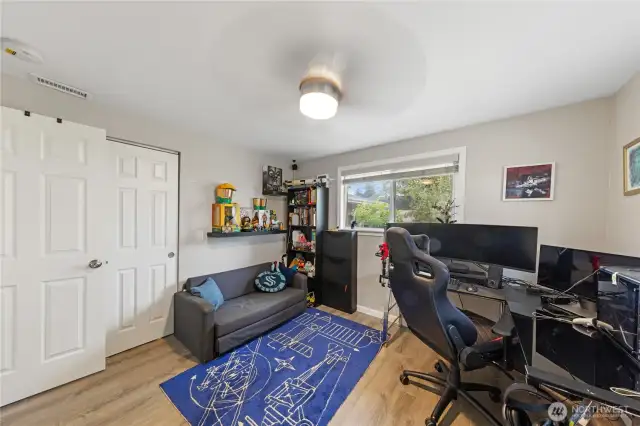 Flexible guest bedroom or gaming room featuring two closets.