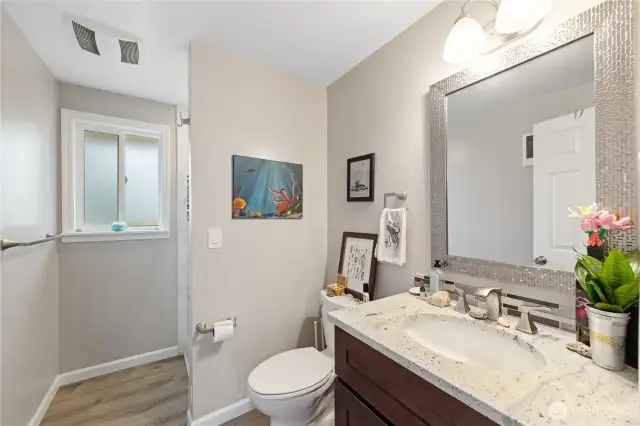 3/4 bath off the dining room also features quartz counter.