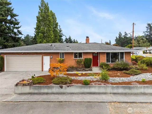 Move in ready look with a brick exterior, bright picture windows, and low maintenance plantings.