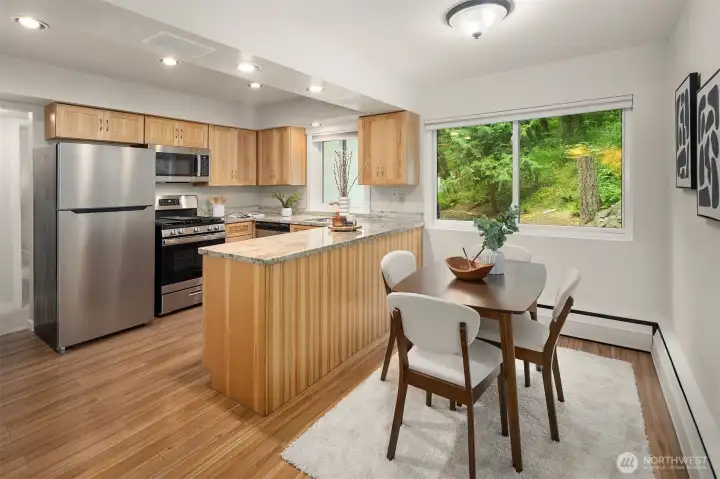 Granite countertops and Stainless Steel appliances with informal eating space
