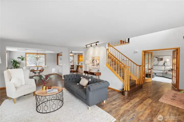 Formal living room, grand staircase and separate family room through the French doors!