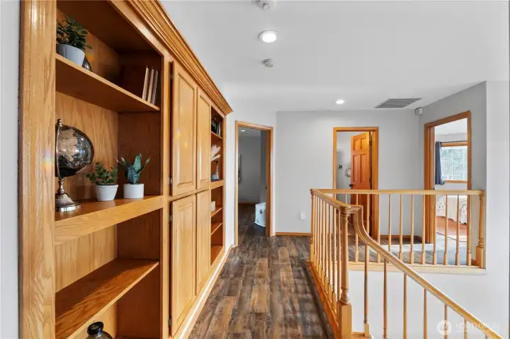 Custom shelving and storage leading to the two additional bedrooms and bathroom.