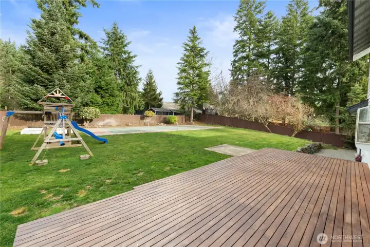 This yard has it all! A large deck for hosting, a hot tab pad (plumbed and wired) for relaxation and a sport court for fun!