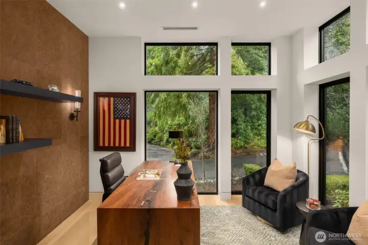 Main level office/den space with leather paneled wall.