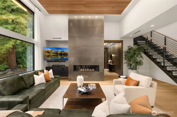 Open great room design flooded with natural light. Walnut wood ceiling paneling.