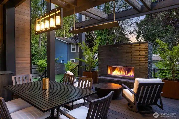 Al Fresco dining with an outdoor fireplace for added warmth and ambience.