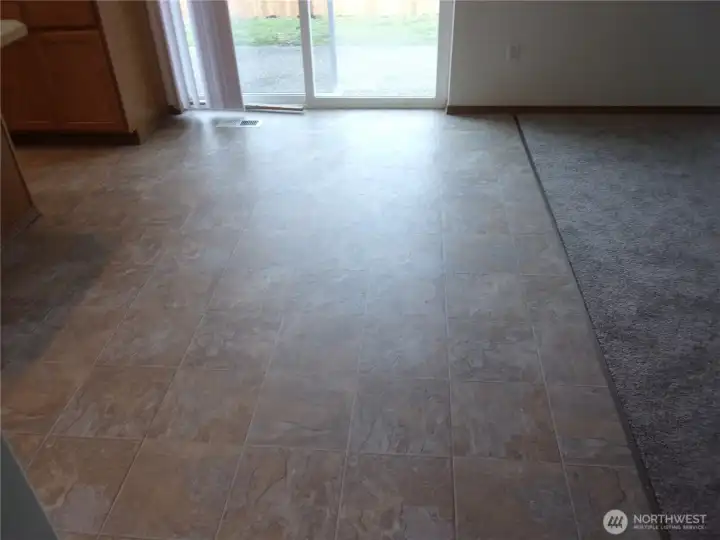 Eating area with slider to fenced back yard and patio.