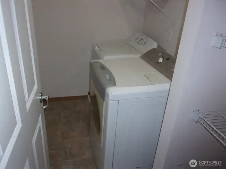 Upstairs laundry room includes washer and dryer.