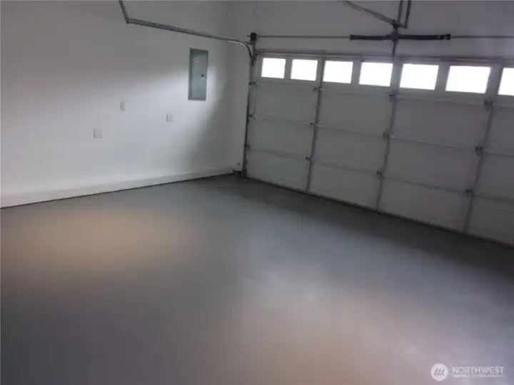 Fully sheet rocked and freshly painted garage with garage door opener.