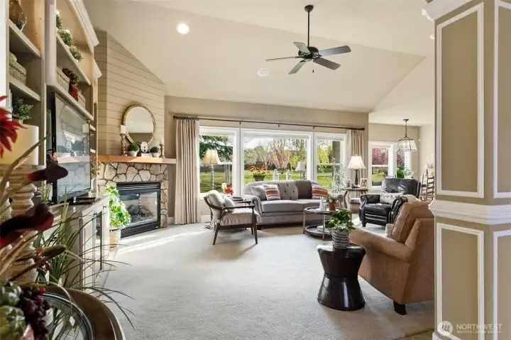 Stone fireplace surround with shiplap accent above.