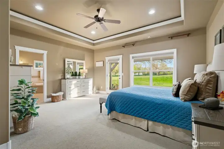 Primary bedroom with recessed lighting and direct access to a second patio.