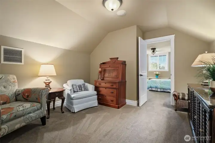 Private upper-level retreat with vaulted ceilings, bedroom #3 & sitting area. Ideal for guests or multi-generational living.