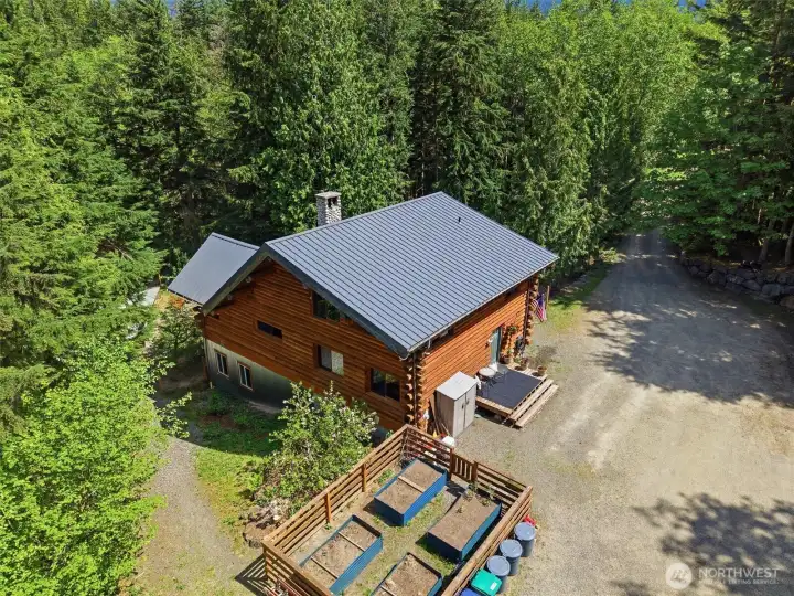 Set on over 6 private acres with fruit trees and garden space