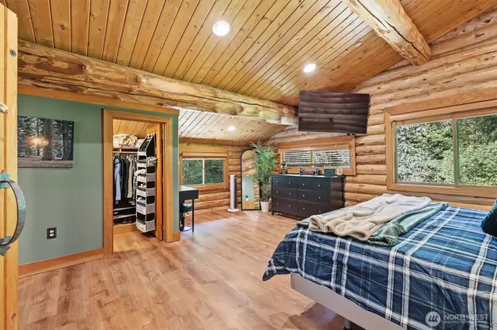Luxurious private primary suite with heated floors and views of the outdoors.
