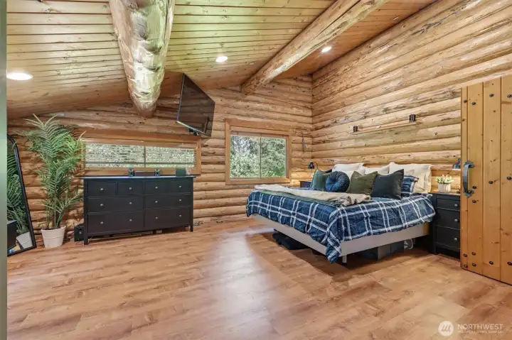 Luxurious private primary suite with heated floors and views of the outdoors.