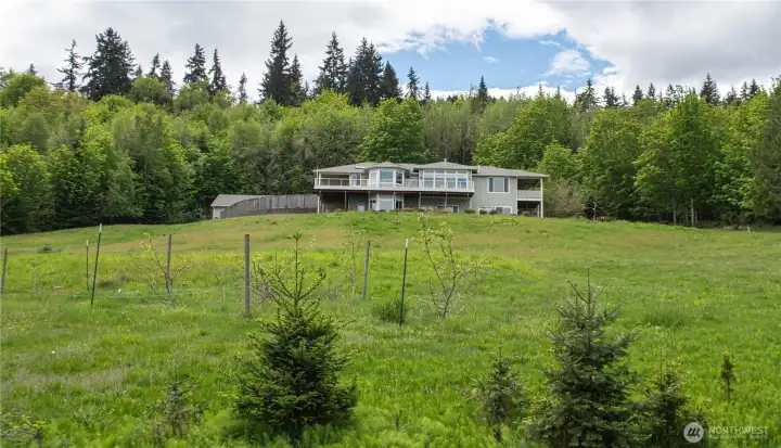 A 10-acre retreat where nature surrounds you and from every window, stunning views of the Strait of Juan de Fuca and Victoria, BC beyond fill the frame.