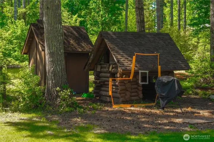 Log cabin play area next to pump house