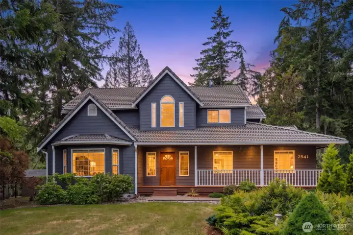 Evening exterior showcasing warm curb appeal and inviting outdoor lighting