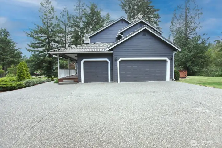 Oversized 3-car attached garage with ample parking and storage.