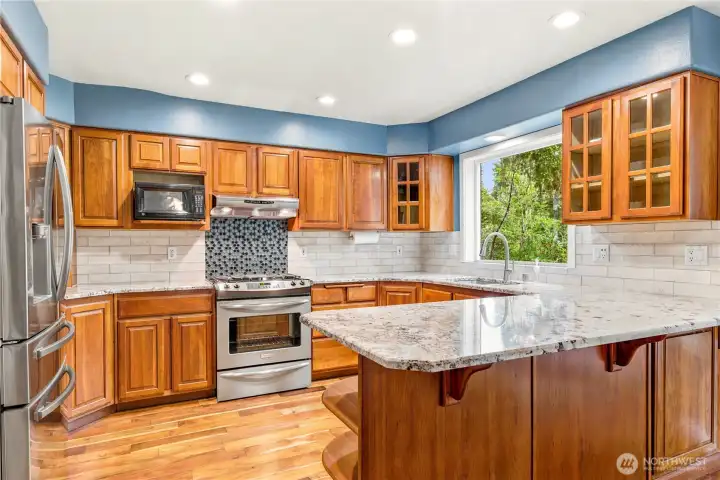 Spacious kitchen with center island and abundant cabinet storage.