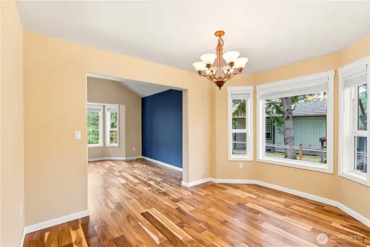Dining area with hardwood floors and natural light throughout.