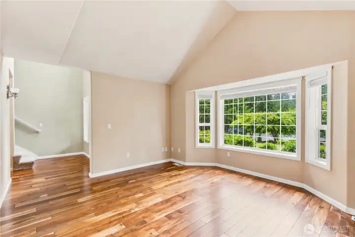Primary suite with vaulted ceilings and large picture windows.