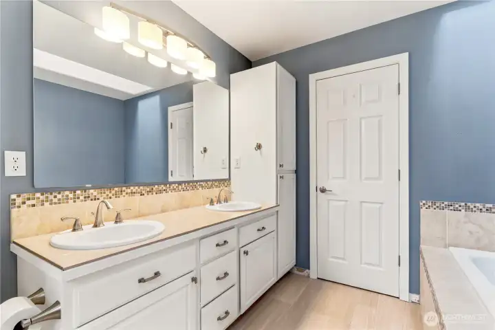 Primary bathroom with double vanity and plenty of storage.