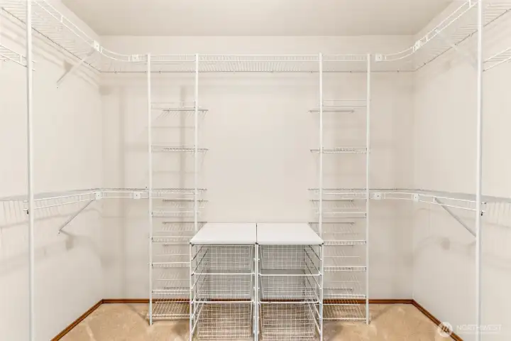 Large walk-in closet with built-in shelving and organization system