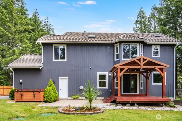 Rear exterior showcasing covered outdoor living space.
