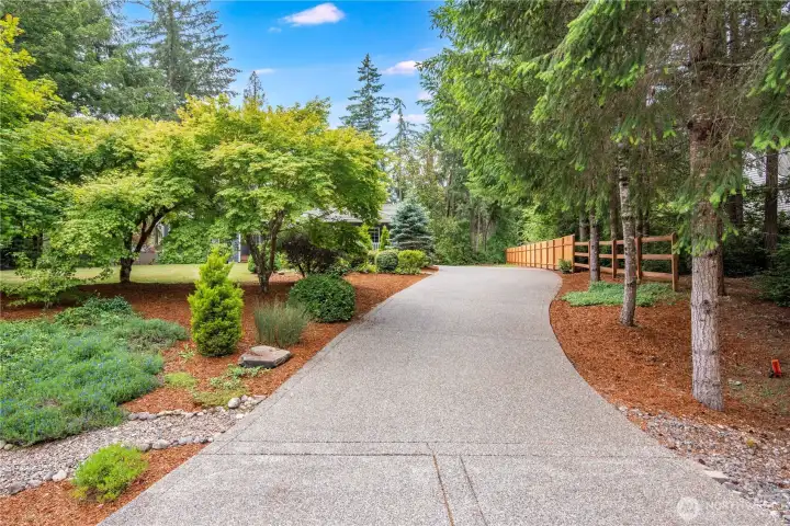 Long private driveway leading to the home and garage.