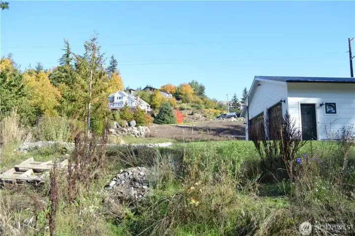 Looking East from NE corner of property - the access alley is just above the pallet. The alley continues west down the entire length of the subject lot from where the improved alley ends.