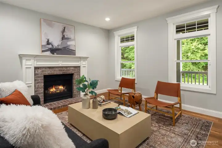 Warm and inviting family room with fireplace, large windows, and direct access to outdoor living spaces.