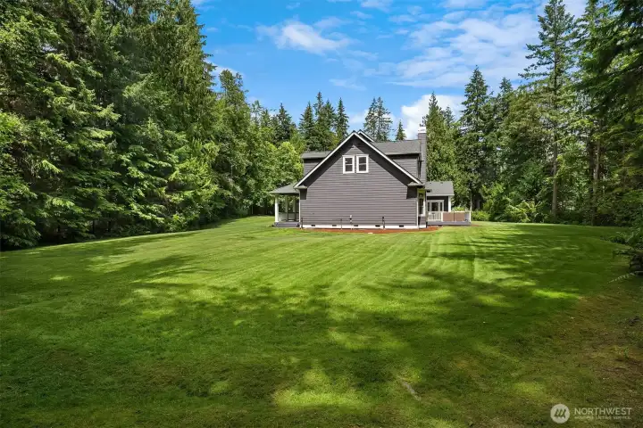 Rare, level backyard with endless lawn, mature landscaping, and room to play, entertain, garden, or simply enjoy the outdoors.