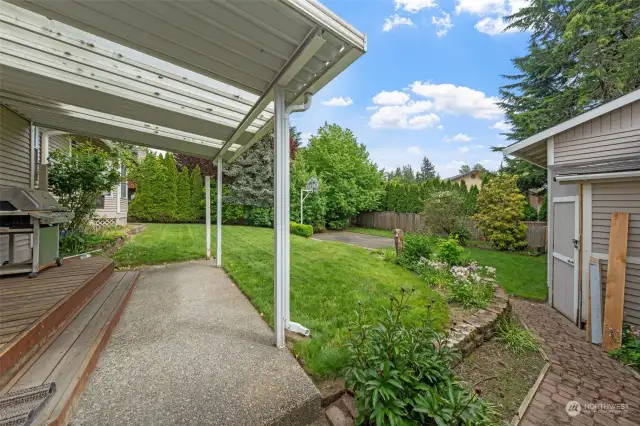Nice covered back patio with a gentle slope or a couple stairs to the detached garage~