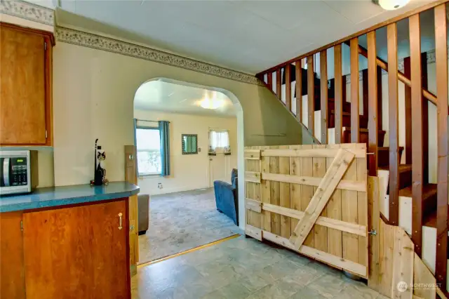 Stairs go to attic space, and the gate is the kennel area for her dog, but can seperate the kitchen and the living room to .