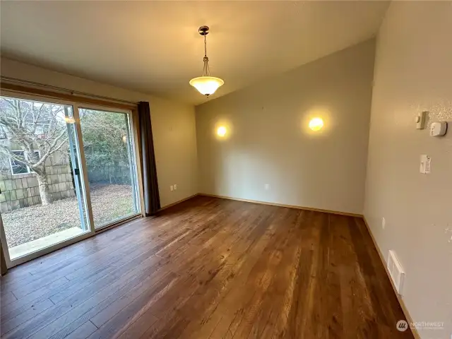 Dining area in kitchen with sliding glass door to fenced backyard