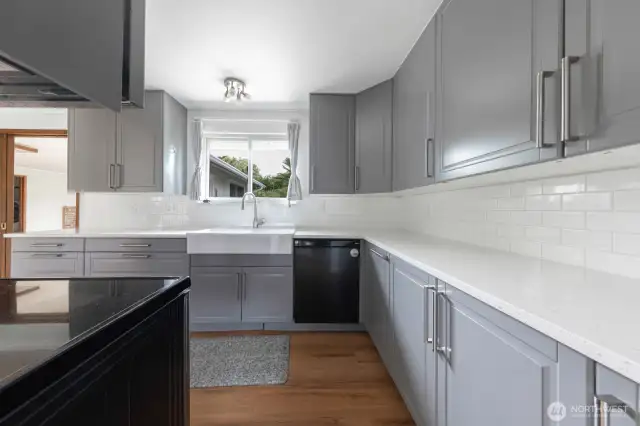 Updated kitchen includes quartz countertops and farm sink