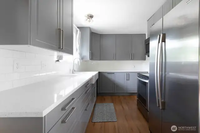 Kitchen includes stainless double door refrigerator