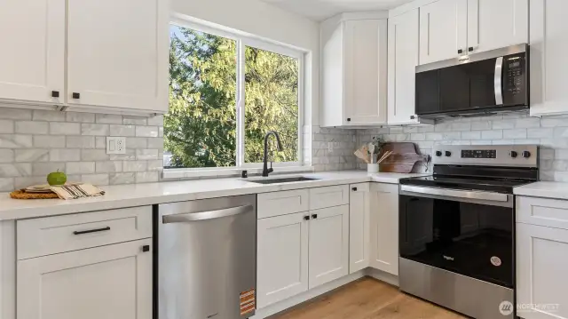 Photos for reference only. Same floor plan similar features. Kitchen is bright and has quartz counters and tile backsplash.