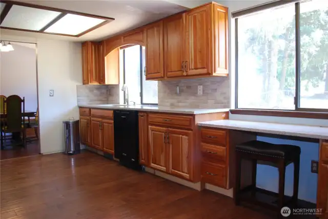 View of the updated kitchen.  Kitchen features newer hand scraped style wood flooring flooring, and brand-new PEX plumbing w/lifetime warranty - bringing peace of mind for years.